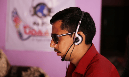 Danish Mahajan working with headphones and assistive glasses.