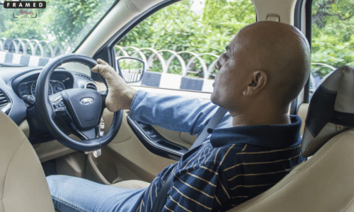 Vikram Agnihotri driving a car with his feet on the steering wheel.